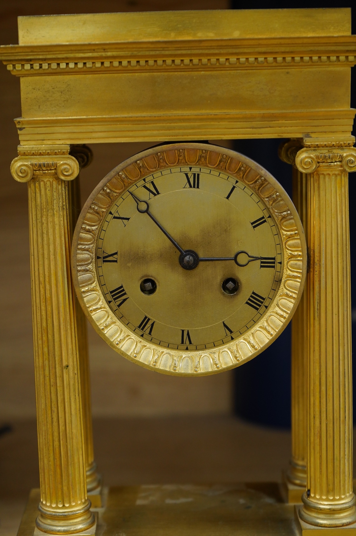 A 19th century French gilt brass eight day portico clock with pendulum, 38cm